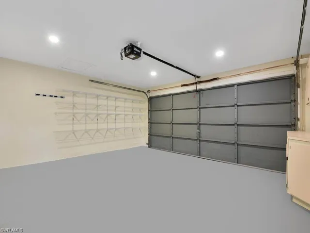 Garage featuring recessed lighting and a garage door opener