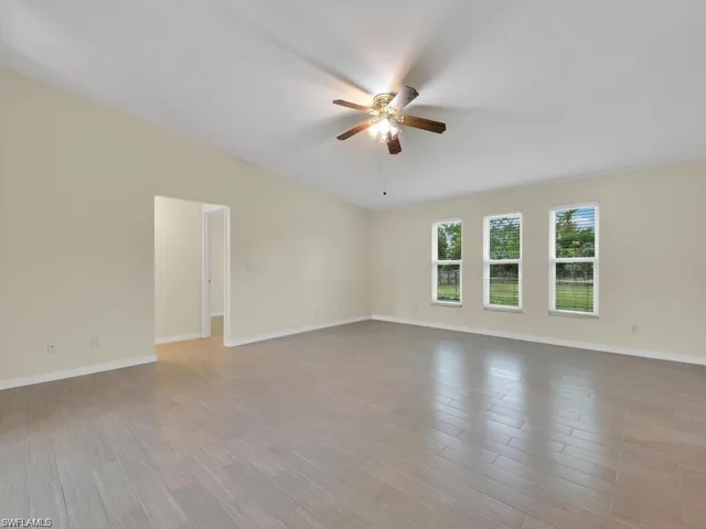 Unfurnished room featuring wood finished floors and a ceiling fan