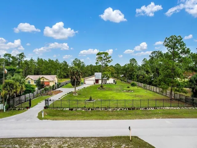 Fenced front yard, and driveway