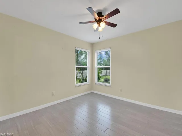Spare room featuring a ceiling fan and light wood-type flooring