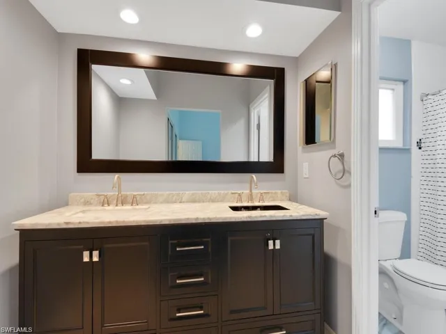 Full bath with double vanity and recessed lighting