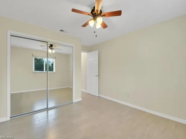 Unfurnished bedroom featuring light wood-type flooring, a closet, and ceiling fan