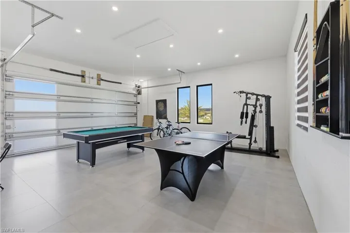 Recreation room featuring a garage, recessed lighting, and billiards