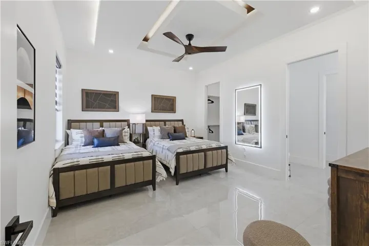 Bedroom with a ceiling fan and recessed lighting