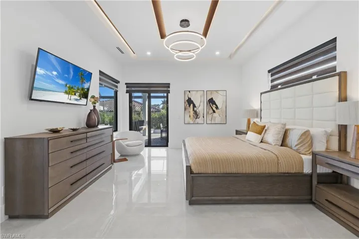 Bedroom with access to exterior and a raised ceiling