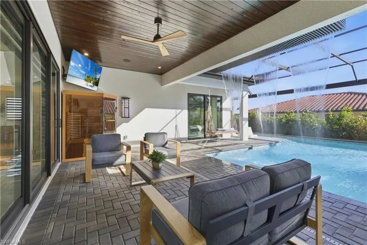 View of patio with a ceiling fan, an outdoor lounge area, and an outdoor pool