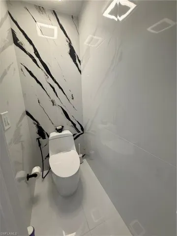 Bathroom with tile patterned flooring and tile walls
