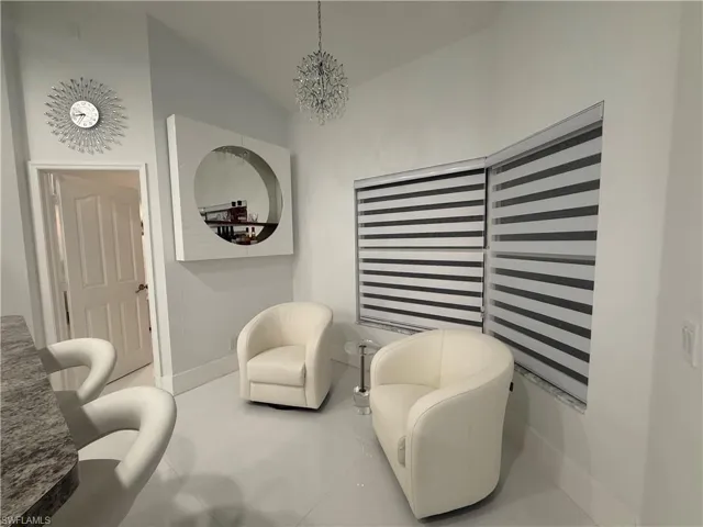 Sitting room featuring a chandelier and tile patterned flooring