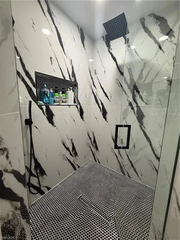 Bathroom view of a marble finish shower