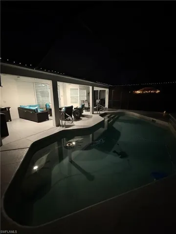 Pool at twilight with an outdoor pool