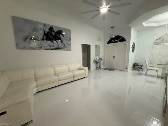 Living room featuring tile patterned floors and a ceiling fan