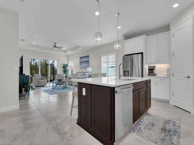 Kitchen with white cabinetry, decorative light fixtures, a kitchen breakfast bar, stainless steel appliances, and recessed lighting