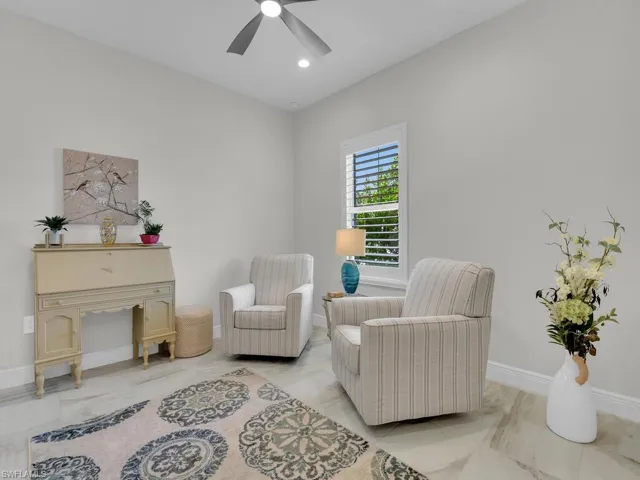 Living area featuring baseboards and recessed lighting