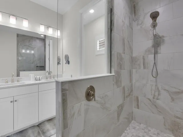 Full bathroom with a walk in shower and double vanity