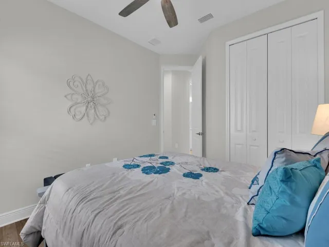 Bedroom with wood finished floors, a closet, and ceiling fan