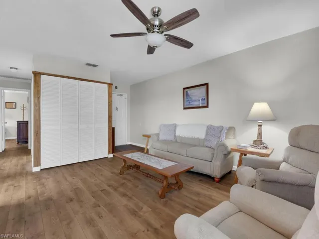 Living room with wood finished floors and ceiling fan