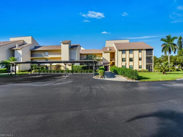 View of building exterior with covered parking