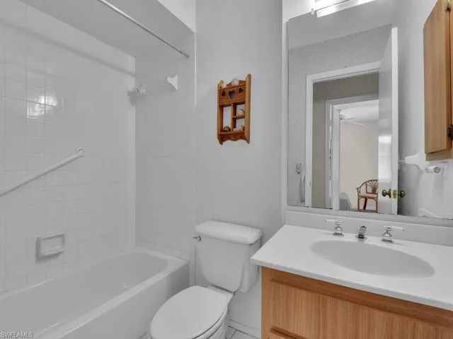 Full bath with vanity and shower / washtub combination