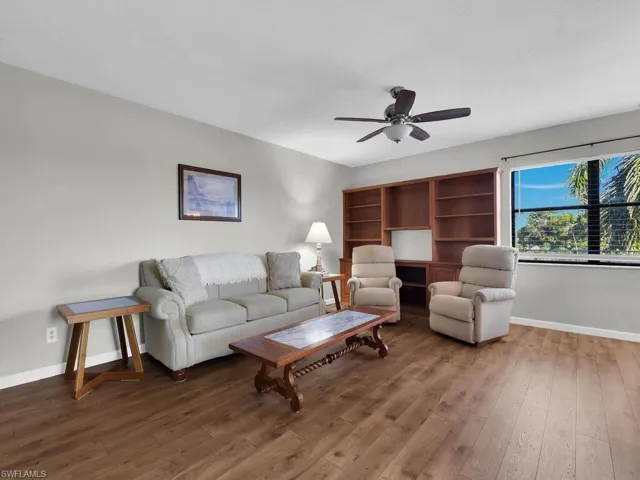 Living area with wood finished floors and ceiling fan