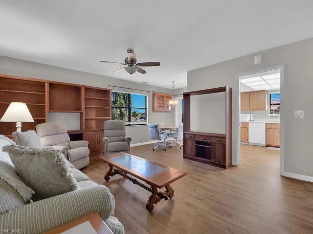 Living area featuring light wood-style flooring, healthy amount of natural light, and a ceiling fan