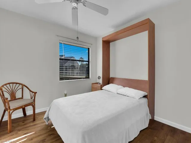 Bedroom featuring dark wood finished floors and a ceiling fan