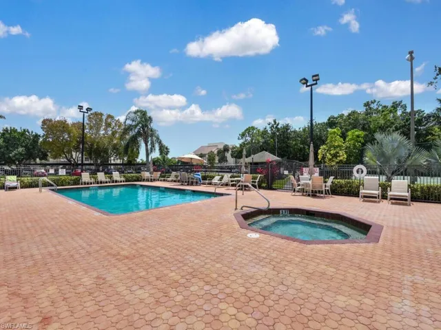Community pool featuring a hot tub and a patio
