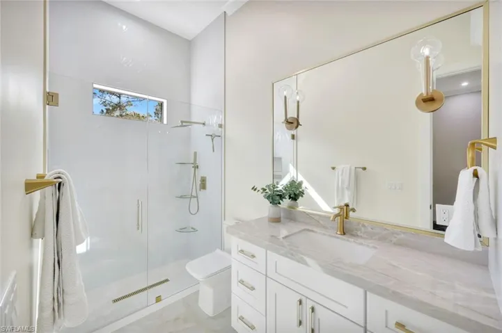 Full bath with a stall shower and vanity