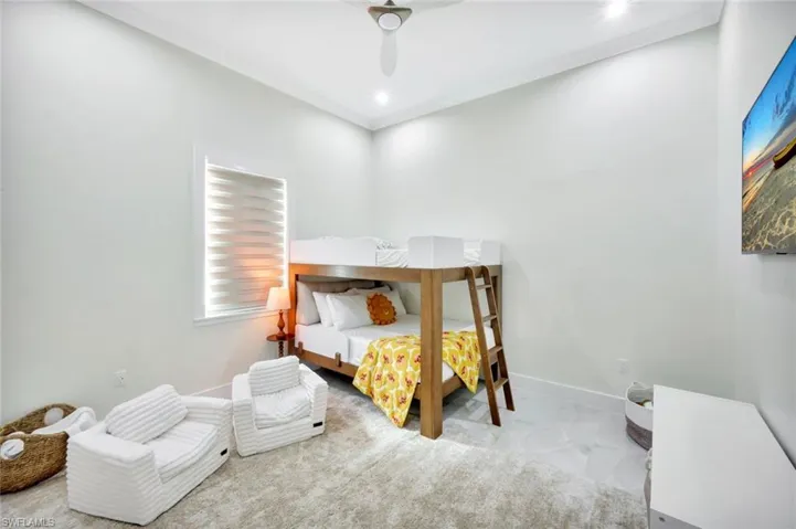 Bedroom with a ceiling fan and crown molding