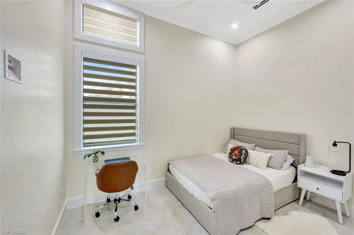 Bedroom with baseboards and a ceiling fan