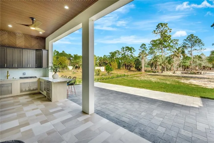 View of patio featuring area for grilling and a ceiling fan