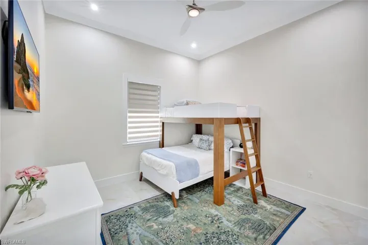 Bedroom featuring marble finish floors, a ceiling fan, and recessed lighting