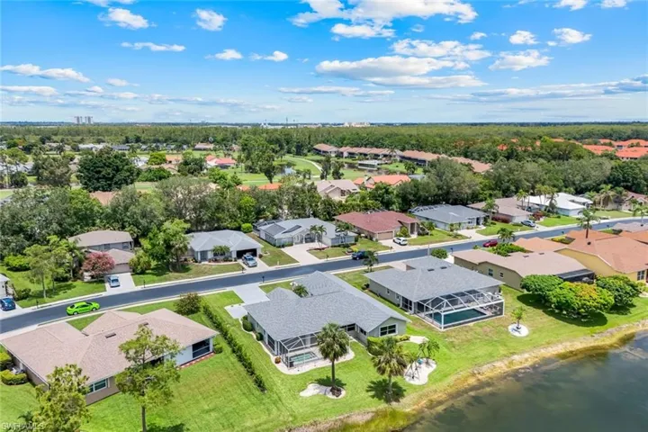 Aerial view of residential area featuring a large body of water