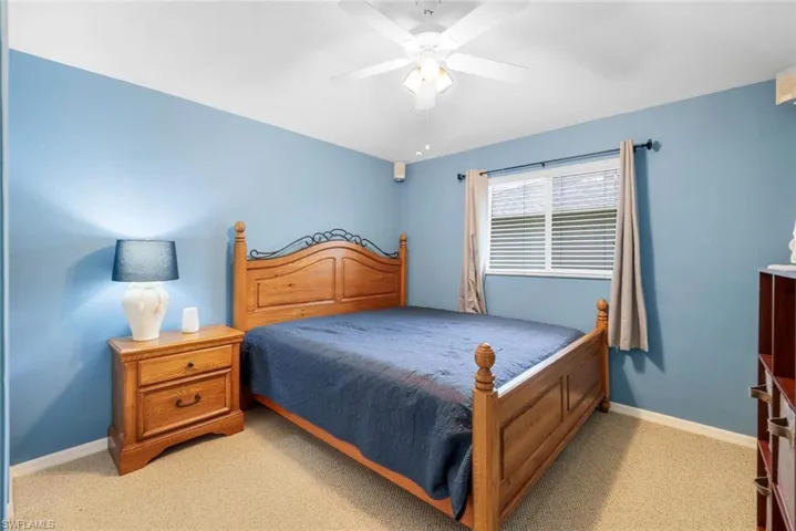 Bedroom featuring light colored carpet and ceiling fan