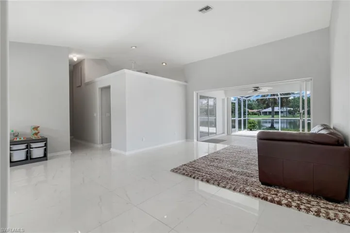 Living area with marble finish floors and ceiling fan