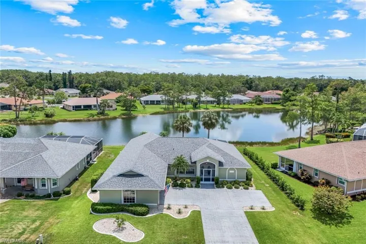 Aerial perspective of suburban area featuring a nearby body of water