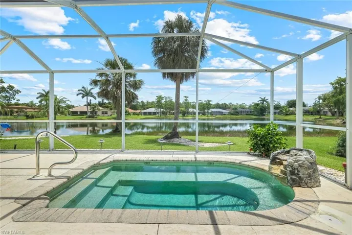 View of pool featuring a water view, a swimming pool, and a yard