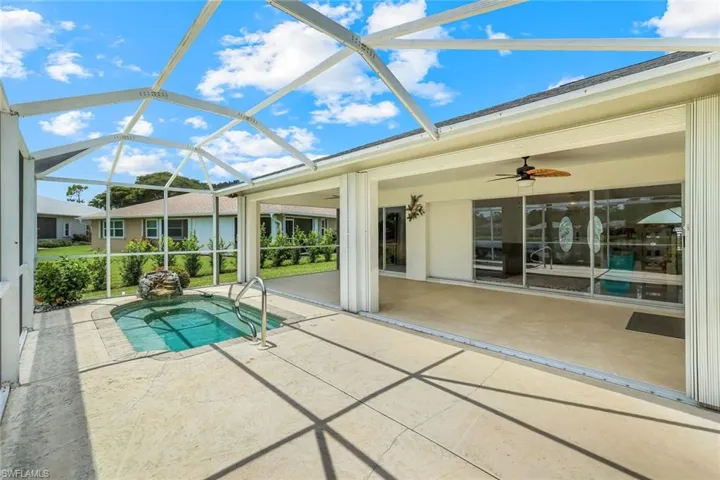 Swimming pool with a patio area, ceiling fan, and a lanai