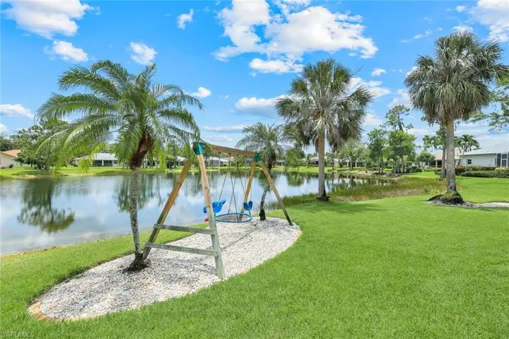 View of grassy yard with a water view