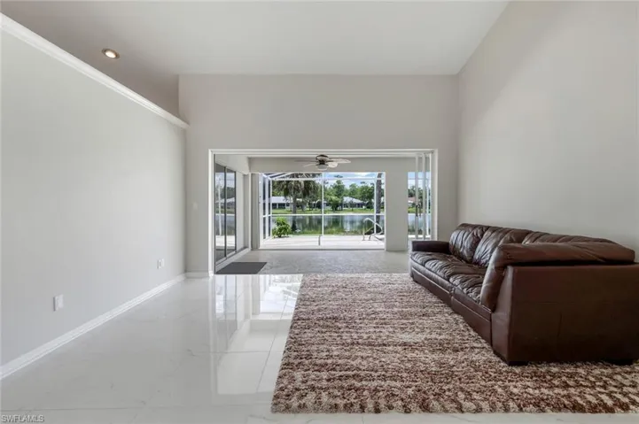 Living room featuring marble finish floors and ceiling fan