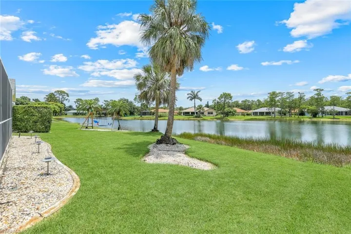 View of grassy yard with a water view