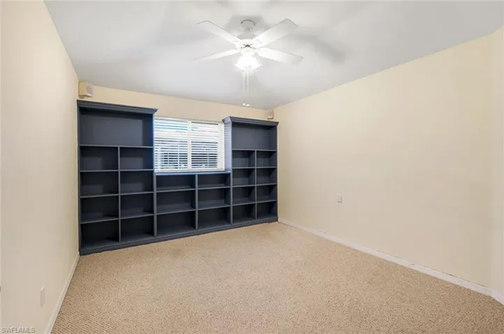 Unfurnished bedroom with carpet floors and a ceiling fan