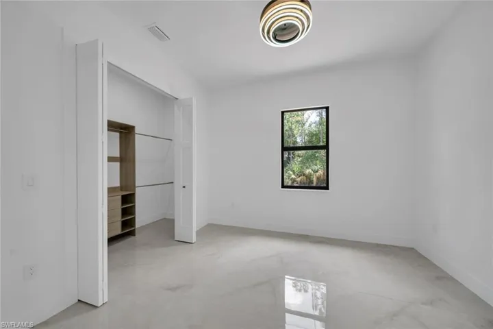 Unfurnished bedroom with visible vents, baseboards, and a closet