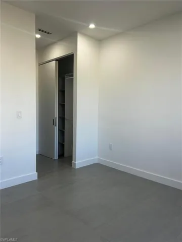 Empty room featuring baseboards and recessed lighting
