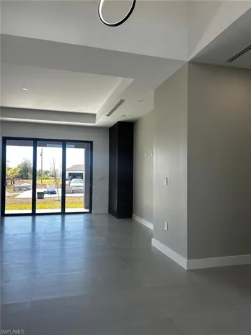 Empty room featuring baseboards and concrete flooring