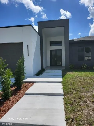 Entrance to property featuring stucco siding and a garage