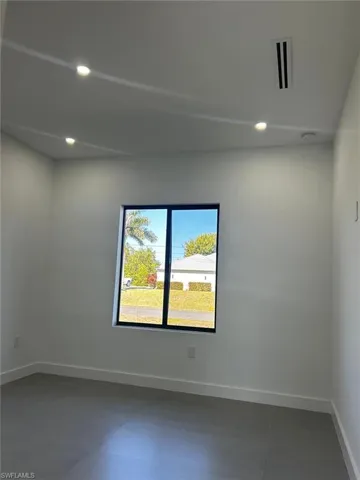 Unfurnished room with baseboards and recessed lighting