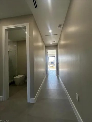 Hallway featuring baseboards and recessed lighting