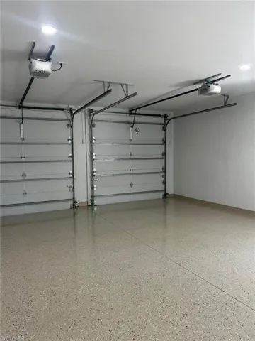 Garage with recessed lighting and a garage door opener