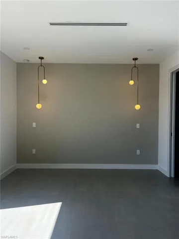 Empty room featuring baseboards