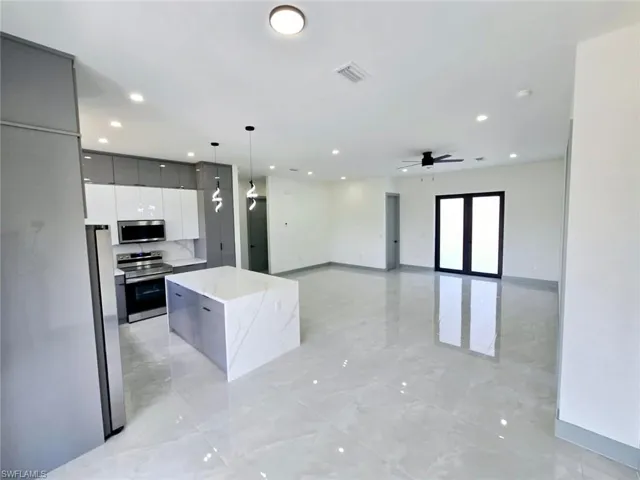 Kitchen with recessed lighting, stainless steel appliances, a center island, visible vents, and modern cabinets